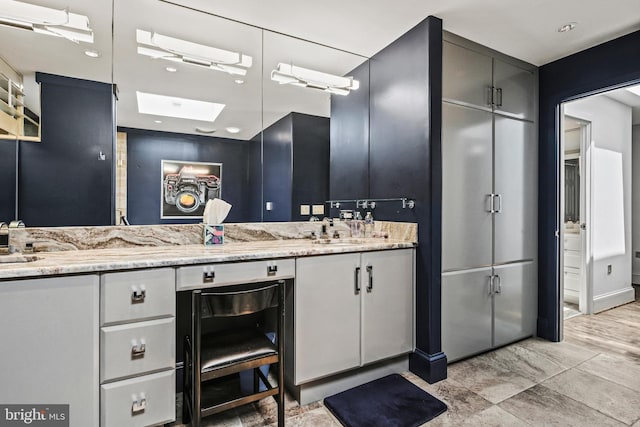 1 Regency Ct Unit 1, Baltimore, MD 21208 - full bathroom featuring double vanity and a skylight