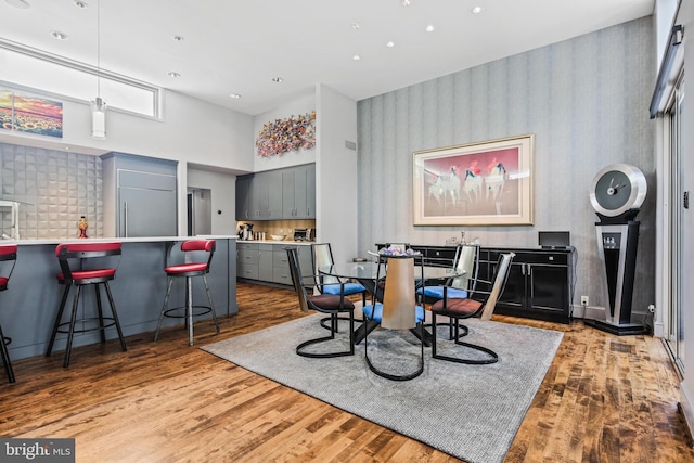 1 Regency Ct Unit 1, Baltimore, MD 21208 - dining space with wallpapered walls, wood finished floors, and a towering ceiling