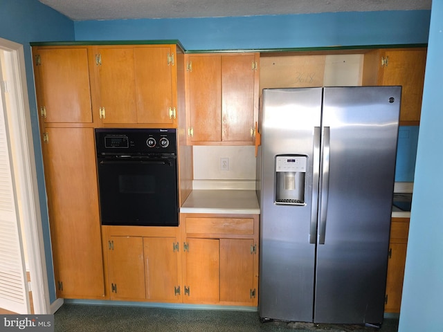 1101 Saint Paul St Unit 1212, Baltimore, MD 21202 - kitchen with stainless steel fridge, oven, light countertops, and brown cabinets