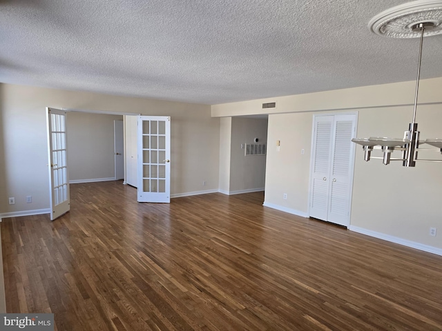 1101 Saint Paul St Unit 1212, Baltimore, MD 21202 - unfurnished room with french doors, dark wood-style flooring, and a textured ceiling