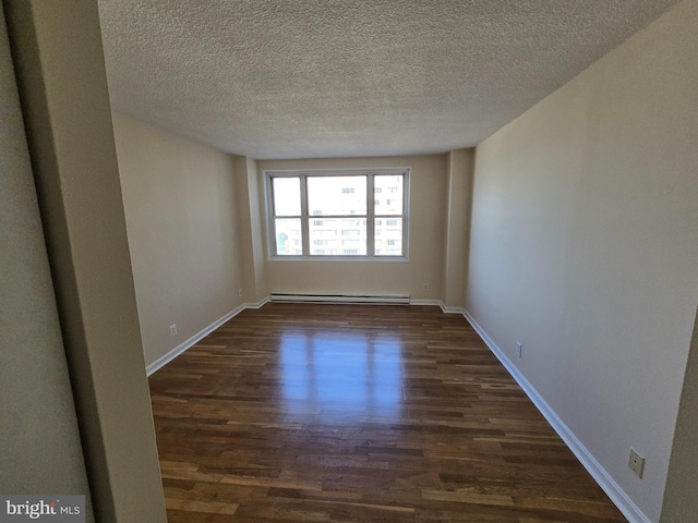 1101 Saint Paul St Unit 1212, Baltimore, MD 21202 - unfurnished room featuring a baseboard radiator, dark wood-type flooring, and a textured ceiling