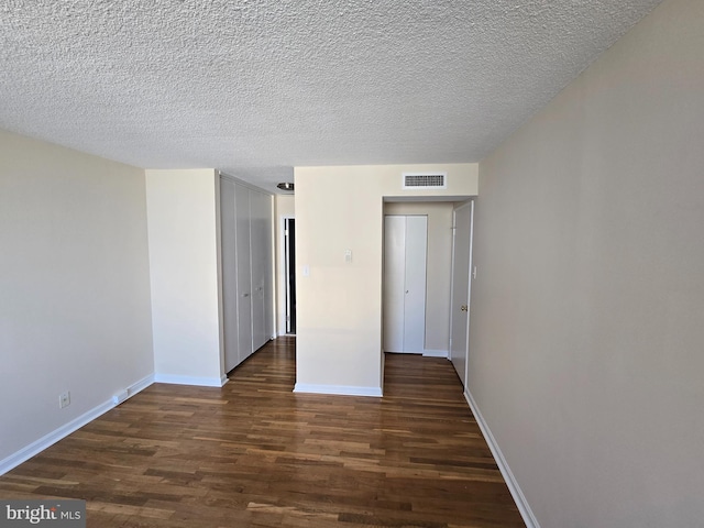 1101 Saint Paul St Unit 1212, Baltimore, MD 21202 - unfurnished bedroom with dark wood-style floors and a textured ceiling