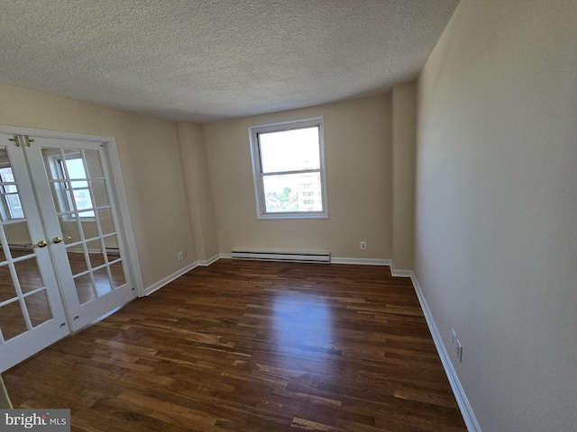 1101 Saint Paul St Unit 1212, Baltimore, MD 21202 - empty room with baseboard heating, french doors, wood finished floors, and a textured ceiling