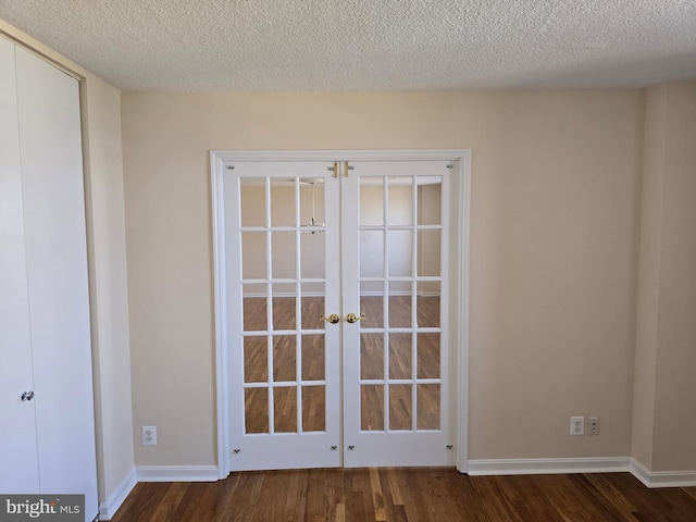 1101 Saint Paul St Unit 1212, Baltimore, MD 21202 - unfurnished room featuring french doors, dark wood-style floors, and a textured ceiling