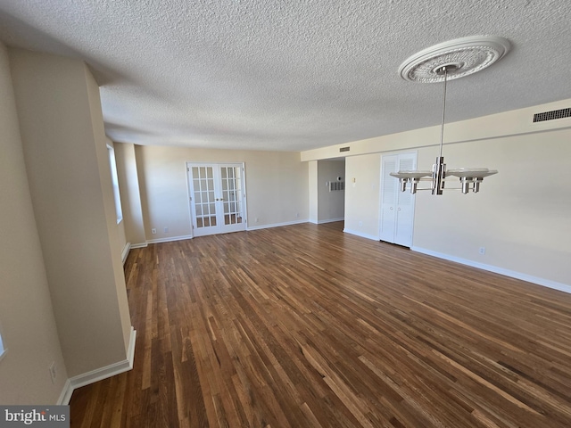 1101 Saint Paul St Unit 1212, Baltimore, MD 21202 - unfurnished living room featuring french doors, a chandelier, dark wood finished floors, and a textured ceiling