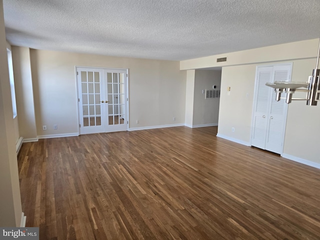 1101 Saint Paul St Unit 1212, Baltimore, MD 21202 - unfurnished living room featuring french doors, dark wood finished floors, a textured ceiling, and baseboard heating
