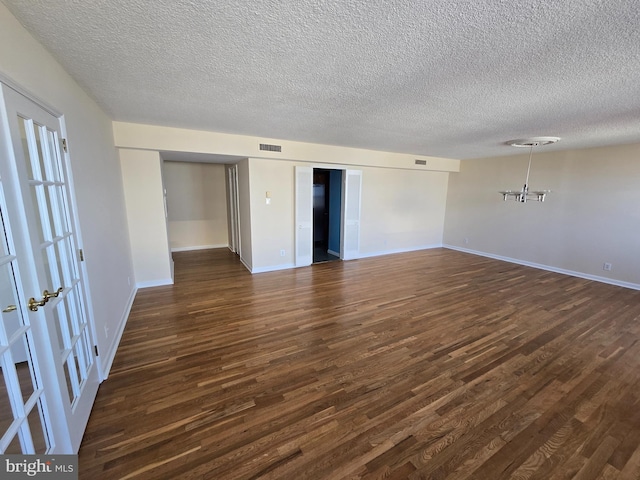 1101 Saint Paul St Unit 1212, Baltimore, MD 21202 - unfurnished bedroom featuring dark wood-style flooring and a textured ceiling