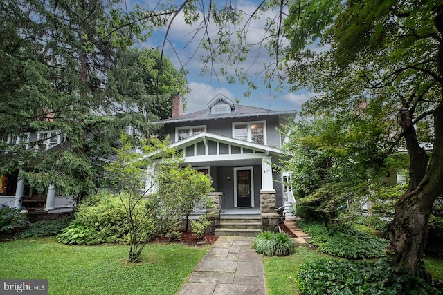 4110 Ingomar St NW, Washington, DC 20015 - american foursquare style home featuring a chimney, a front yard, and a porch