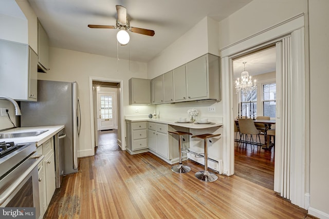 4110 Ingomar St NW, Washington, DC 20015 - kitchen featuring stainless steel range oven, a ceiling fan, light wood finished floors, and gray cabinetry