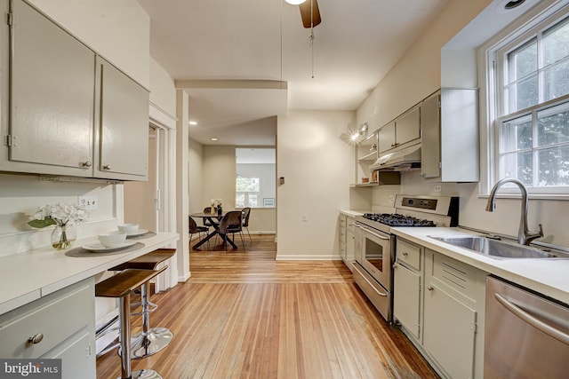 4110 Ingomar St NW, Washington, DC 20015 - kitchen featuring appliances with stainless steel finishes, under cabinet range hood, light countertops, light wood-style flooring, and recessed lighting