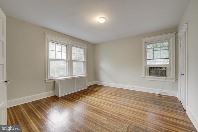 4110 Ingomar St NW, Washington, DC 20015 - spare room with healthy amount of natural light, radiator, wood-type flooring, and cooling unit