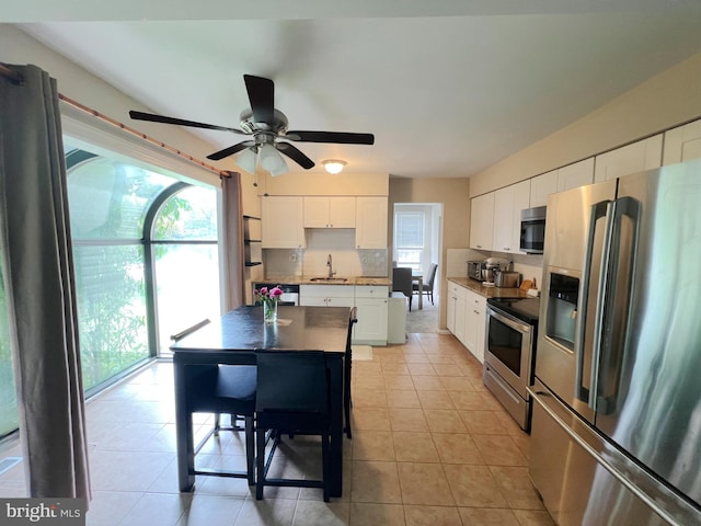 203 Spring Dr, Voorhees, NJ 08043 - kitchen featuring stainless steel appliances, tasteful backsplash, white cabinetry, ceiling fan, and light tile patterned floors