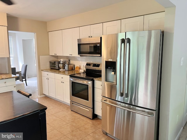 203 Spring Dr, Voorhees, NJ 08043 - kitchen featuring appliances with stainless steel finishes, backsplash, white cabinetry, light tile patterned floors, and light stone counters