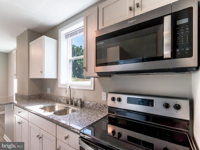 2450 Happy Creek Rd, Front Royal, VA 22630 - kitchen with appliances with stainless steel finishes, white cabinets, and light stone counters