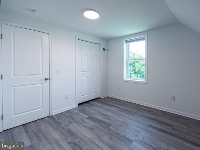 2450 Happy Creek Rd, Front Royal, VA 22630 - unfurnished bedroom featuring wood finished floors and vaulted ceiling