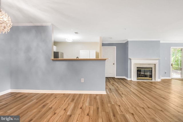 20406 Shore Harbour Dr Unit 4-A, Germantown, MD 20874 - unfurnished living room featuring crown molding, wood finished floors, a chandelier, and a glass covered fireplace