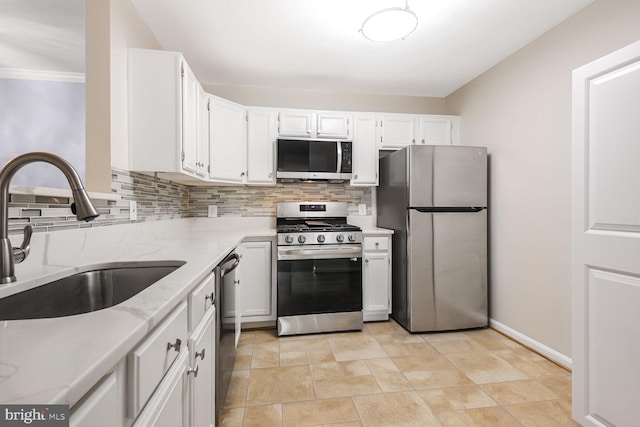 20406 Shore Harbour Dr Unit 4-A, Germantown, MD 20874 - kitchen featuring appliances with stainless steel finishes, decorative backsplash, light stone counters, white cabinets, and crown molding