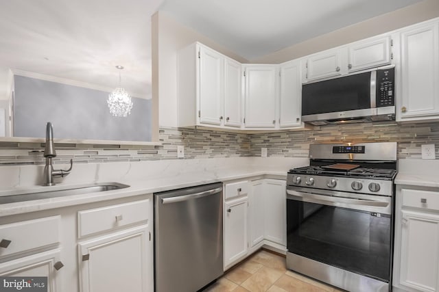 20406 Shore Harbour Dr Unit 4-A, Germantown, MD 20874 - kitchen featuring appliances with stainless steel finishes, tasteful backsplash, white cabinets, a chandelier, and light stone counters