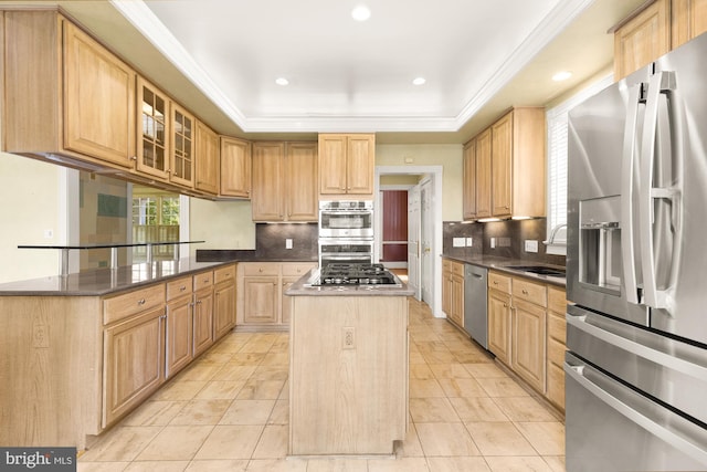 4621 Laverock Pl NW, Washington, DC 20007 - kitchen featuring appliances with stainless steel finishes, backsplash, a center island, light brown cabinetry, and ornamental molding