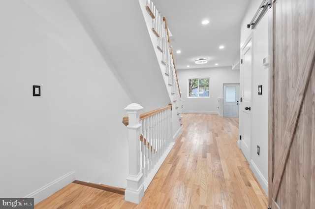 2002 E Lafayette Ave, Baltimore, MD 21213 - hallway with a barn door, light wood-style floors, and recessed lighting