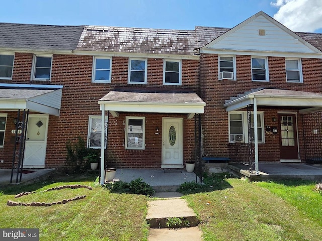 5047 Frederick Ave, Baltimore, MD 21229 - multi unit property featuring a front yard, brick siding, and cooling unit