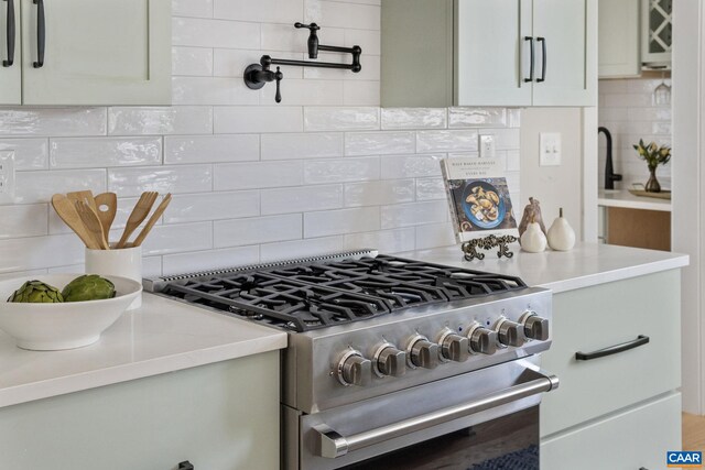 1603 Griffen Grv, Charlottesville, VA 22901 - kitchen with stainless steel gas range, backsplash, and light countertops
