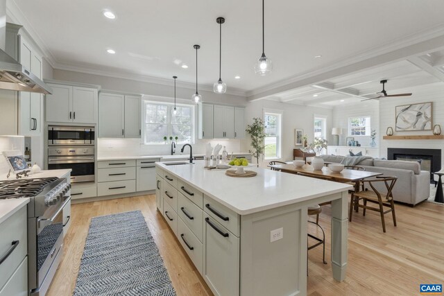 1603 Griffen Grv, Charlottesville, VA 22901 - kitchen featuring appliances with stainless steel finishes, wall chimney range hood, decorative backsplash, a kitchen breakfast bar, and ceiling fan
