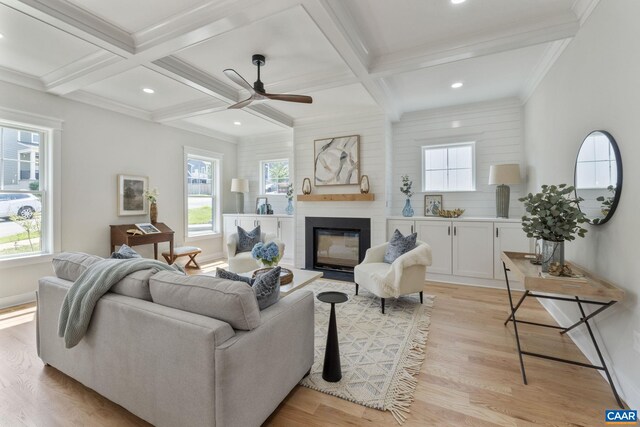 1603 Griffen Grv, Charlottesville, VA 22901 - living area with light wood-style flooring, beamed ceiling, coffered ceiling, a glass covered fireplace, and a ceiling fan
