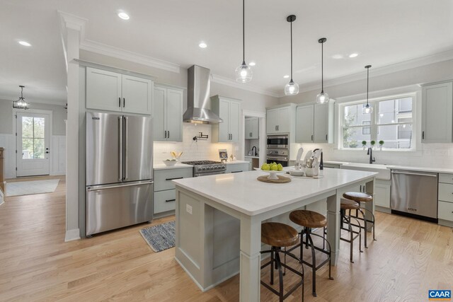 1603 Griffen Grv, Charlottesville, VA 22901 - kitchen featuring stainless steel appliances, wall chimney exhaust hood, decorative backsplash, crown molding, and light countertops