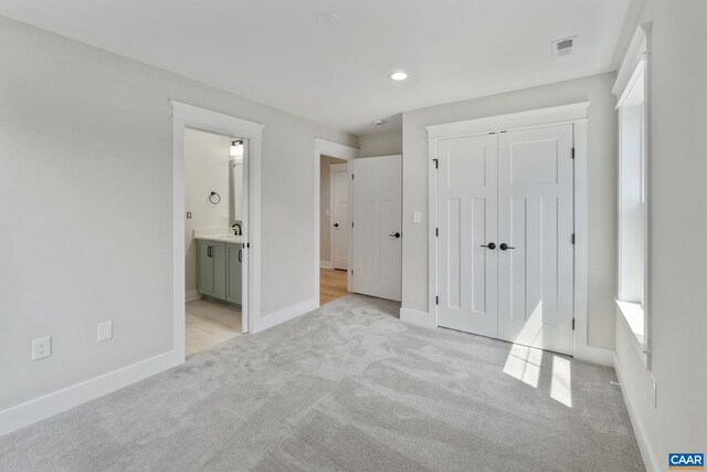 1603 Griffen Grv, Charlottesville, VA 22901 - unfurnished bedroom featuring light carpet, a closet, recessed lighting, and connected bathroom