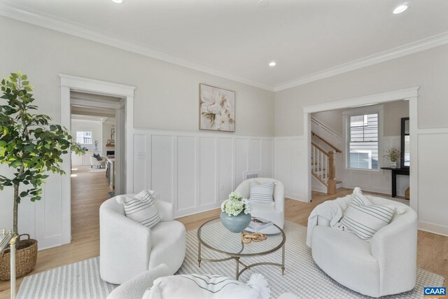 1603 Griffen Grv, Charlottesville, VA 22901 - living area with stairs, a decorative wall, wainscoting, light wood finished floors, and healthy amount of natural light