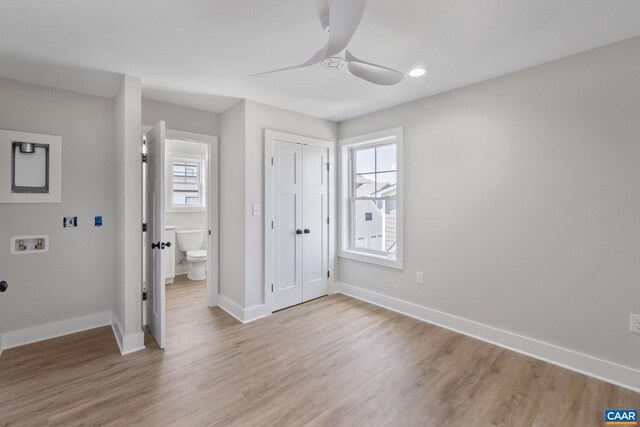 1603 Griffen Grv, Charlottesville, VA 22901 - unfurnished bedroom with multiple windows, light wood-type flooring, a closet, and ceiling fan
