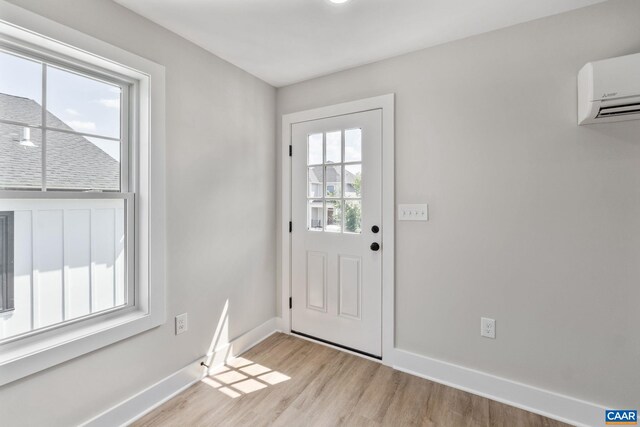 1603 Griffen Grv, Charlottesville, VA 22901 - doorway featuring light wood-style flooring and a wall unit AC