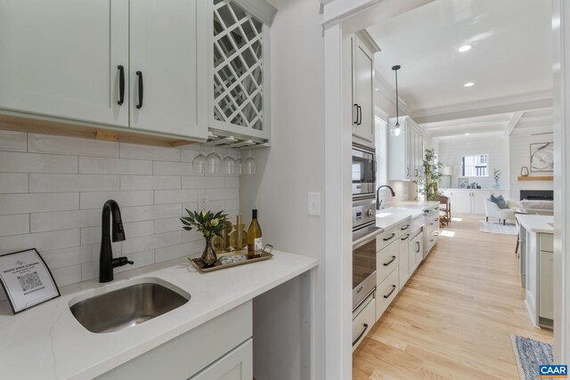 1603 Griffen Grv, Charlottesville, VA 22901 - kitchen with decorative backsplash, appliances with stainless steel finishes, open floor plan, decorative light fixtures, and light wood-style floors