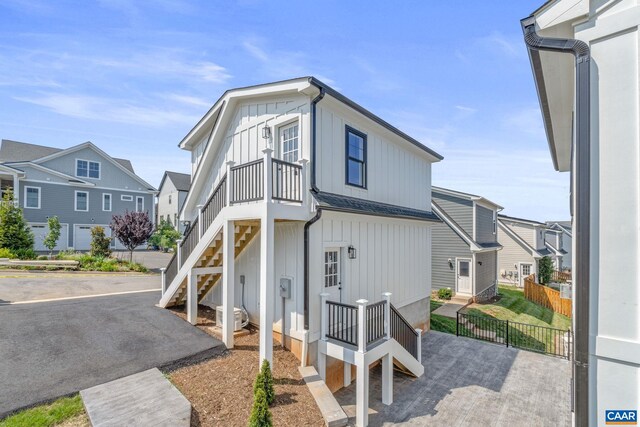 1603 Griffen Grv, Charlottesville, VA 22901 - view of front facade with board and batten siding, stairs, and a residential view