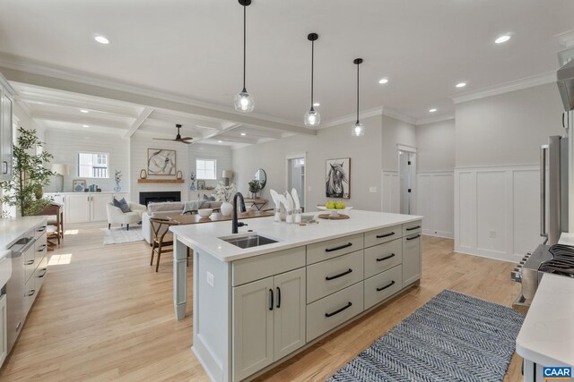1603 Griffen Grv, Charlottesville, VA 22901 - kitchen featuring a ceiling fan, a fireplace, an island with sink, light wood-style flooring, and light countertops