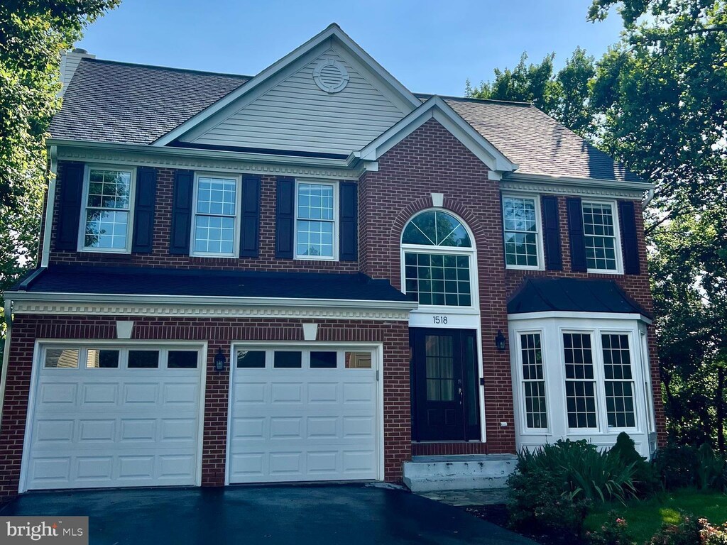 1518 Summerset Pl, Herndon, VA 20170 - view of front of house with a garage, asphalt driveway, and brick siding