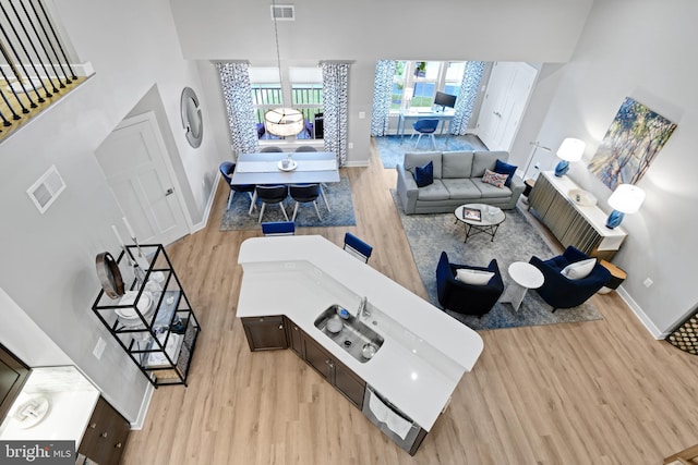 3421 Angelica Way Unit 404, Frederick, MD 21704 - living room featuring wood finished floors and a towering ceiling