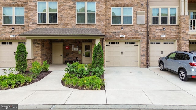 3421 Angelica Way Unit 404, Frederick, MD 21704 - view of front of property with driveway, a garage, and roof with shingles