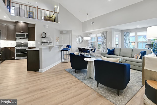 3421 Angelica Way Unit 404, Frederick, MD 21704 - living area featuring light wood-type flooring, high vaulted ceiling, and recessed lighting