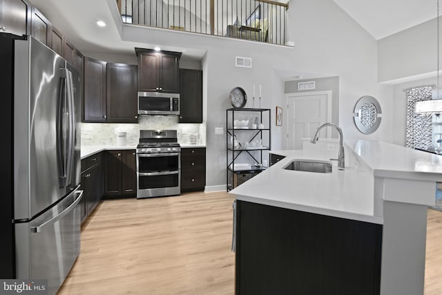 3421 Angelica Way Unit 404, Frederick, MD 21704 - kitchen featuring stainless steel appliances, light wood finished floors, light countertops, and high vaulted ceiling
