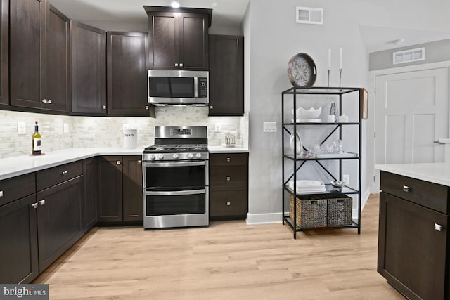 3421 Angelica Way Unit 404, Frederick, MD 21704 - kitchen with stainless steel appliances, light wood-style flooring, tasteful backsplash, light countertops, and dark brown cabinetry