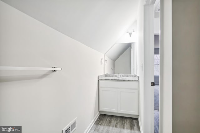 104 Clark Ct, Millington, MD 21651 - bathroom with wood finished floors, vanity, and lofted ceiling