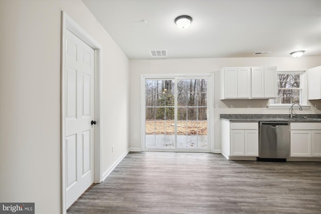 104 Clark Ct, Millington, MD 21651 - kitchen with stainless steel dishwasher, dark countertops, wood finished floors, and white cabinets