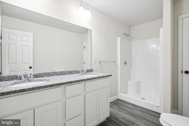 104 Clark Ct, Millington, MD 21651 - bathroom featuring wood finished floors, double vanity, and a shower