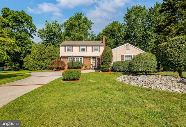 124 Connecticut Ave, Cherry Hill, NJ 08002 - colonial house with brick siding, a chimney, a front yard, and driveway