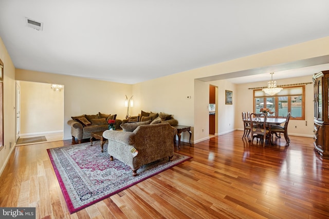 4 Monterey Ln, Manalapan, NJ 07726 - living room with a chandelier and light wood-style floors