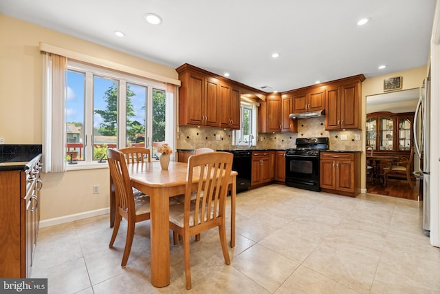 4 Monterey Ln, Manalapan, NJ 07726 - kitchen featuring black appliances, under cabinet range hood, dark countertops, brown cabinets, and recessed lighting