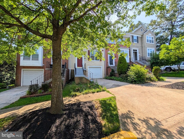 7805 Chartwell Pl, Greenbelt, MD 20770 - view of front of house featuring a garage, driveway, and brick siding