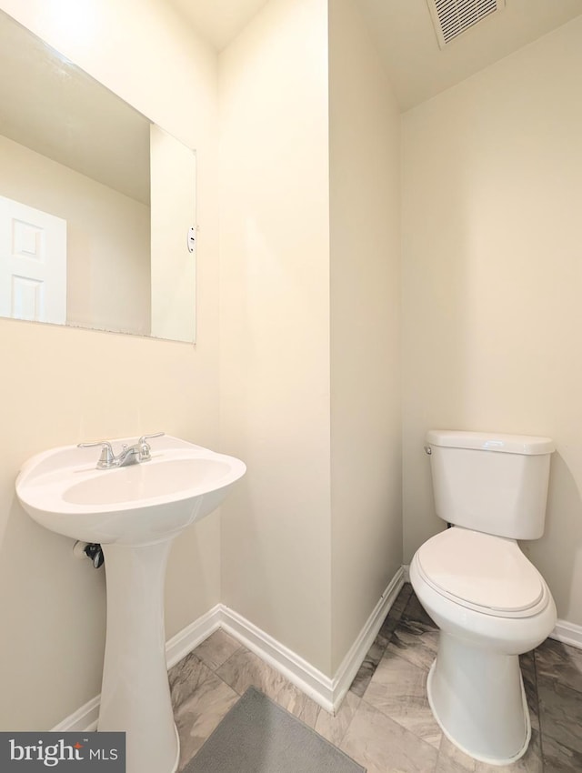 7805 Chartwell Pl, Greenbelt, MD 20770 - half bath featuring baseboards and marble look tiles